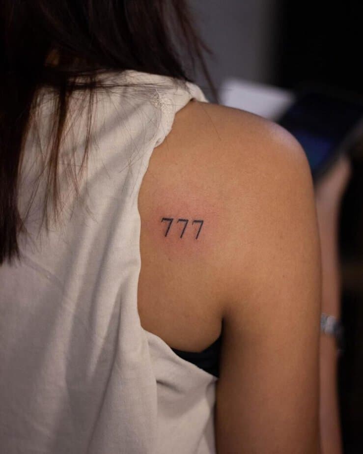 17. A tattoo of angel number 777 on the shoulder 
