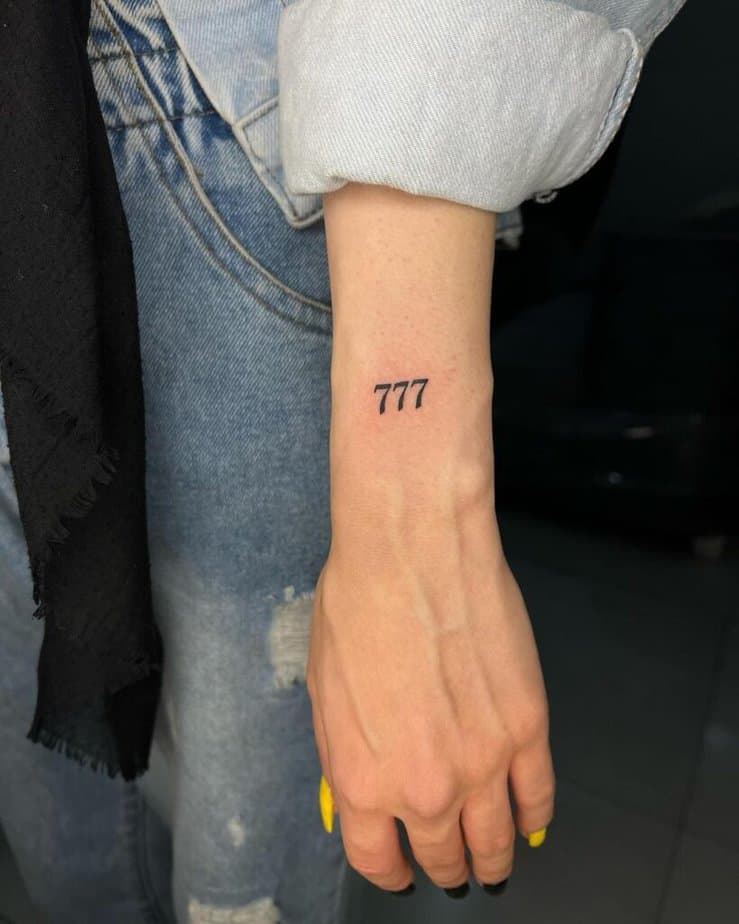 22. A 777 hand tattoo