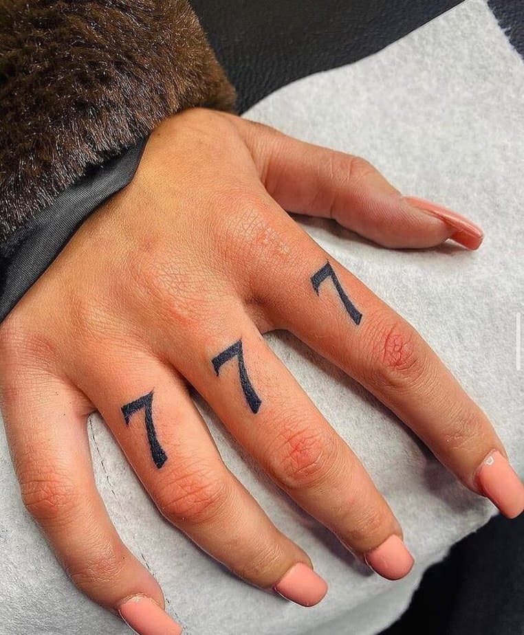 3. A finger tattoo of angel number 777
