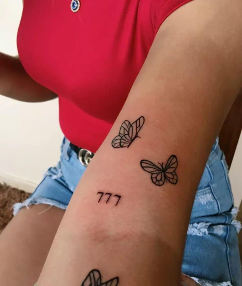 8. A 777 tattoo with butterflies