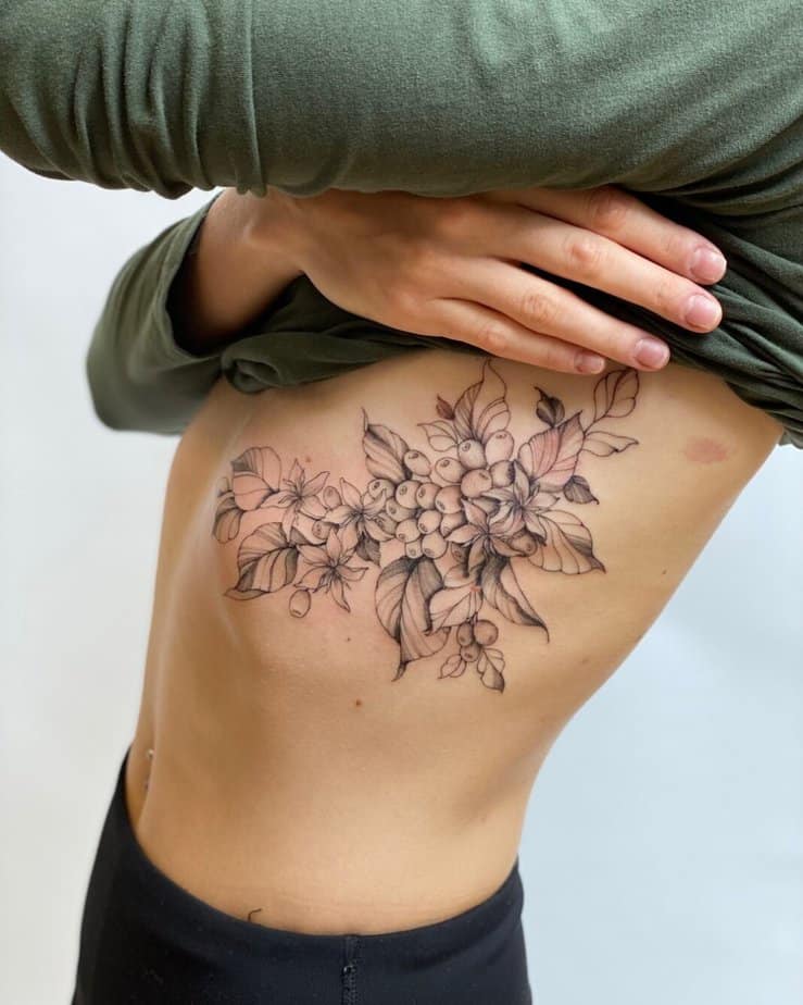 Stay close to your heart with a coffee plant tattoo on your rib cage