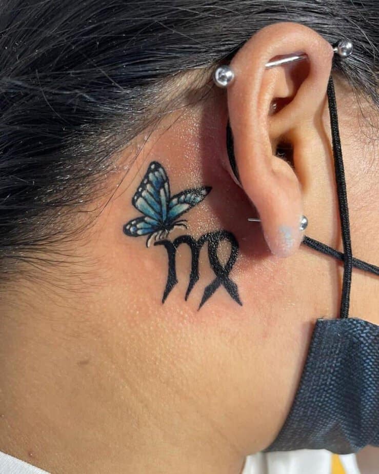 12. A tattoo of a butterfly and a Zodiac sign 