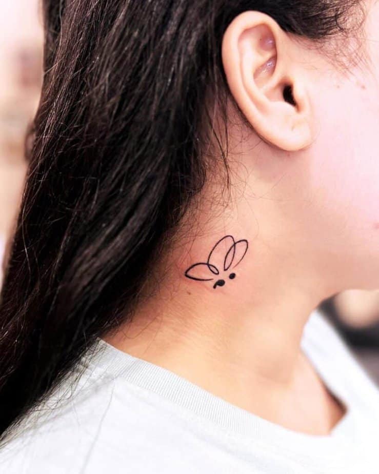 18. A tattoo of a butterfly and a semicolon