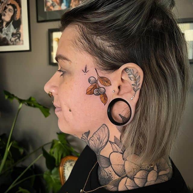 15. Trendy botanical face tattoos for women