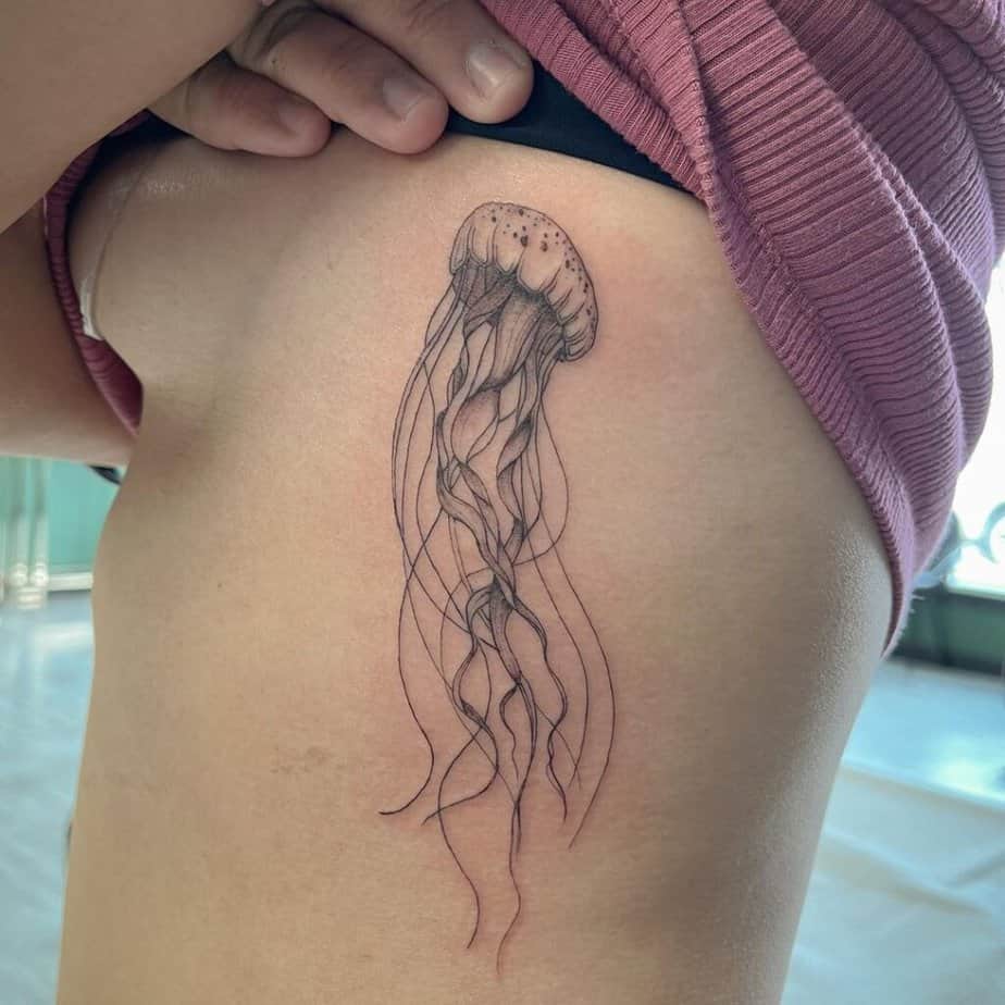 9. A tattoo of a jellyfish on the ribcage