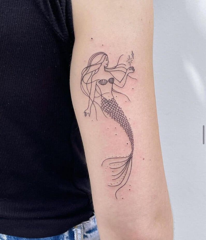 12. A delicate and dainty mermaid tattoo 