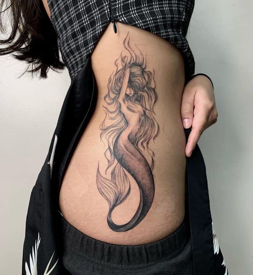 14. A mermaid tattoo on the side of the stomach