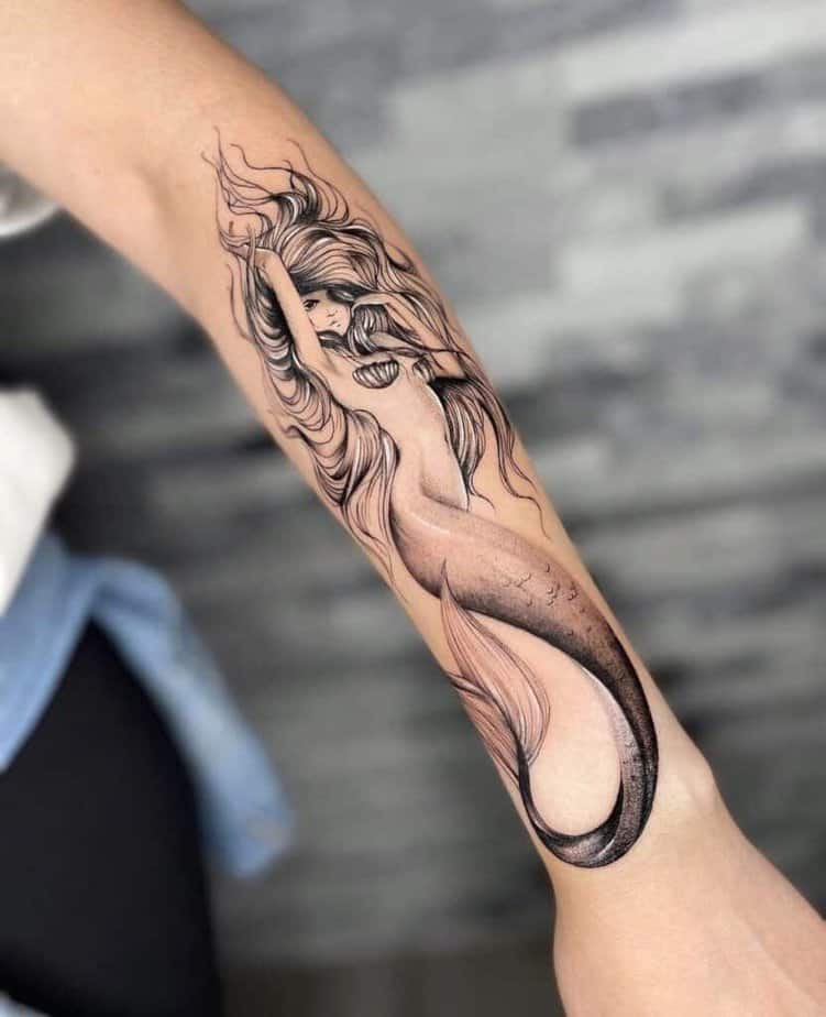 19. A soft and sleek mermaid tattoo 