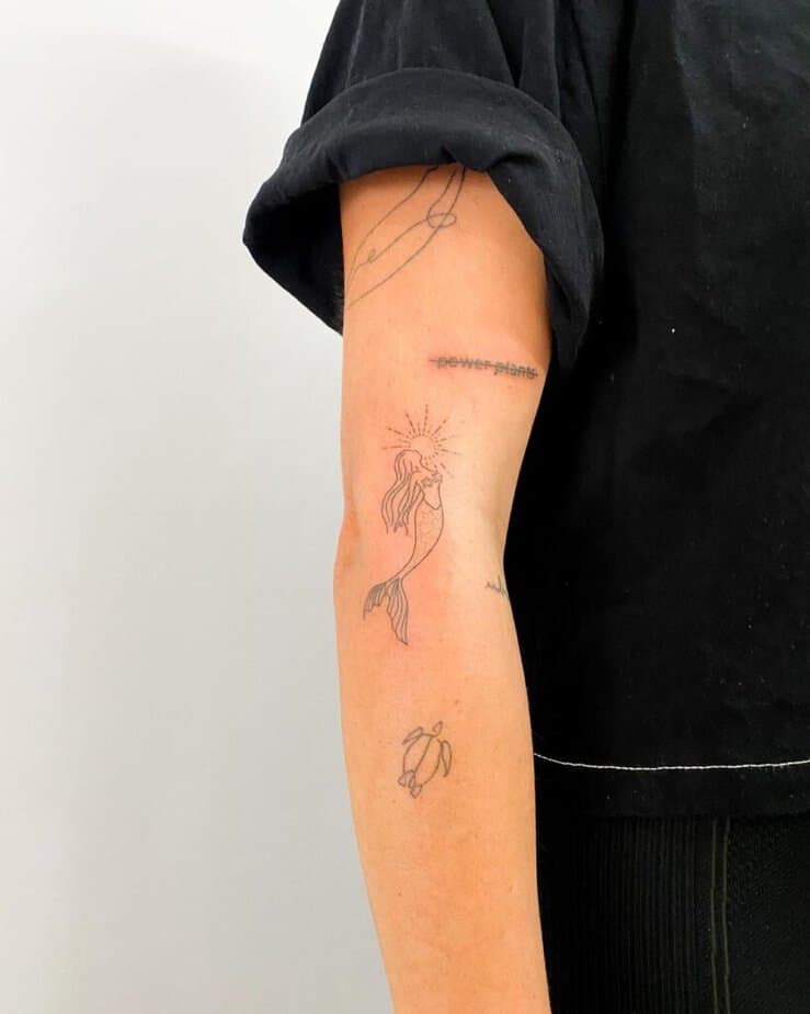 24. A mermaid sticker sleeve tattoo 