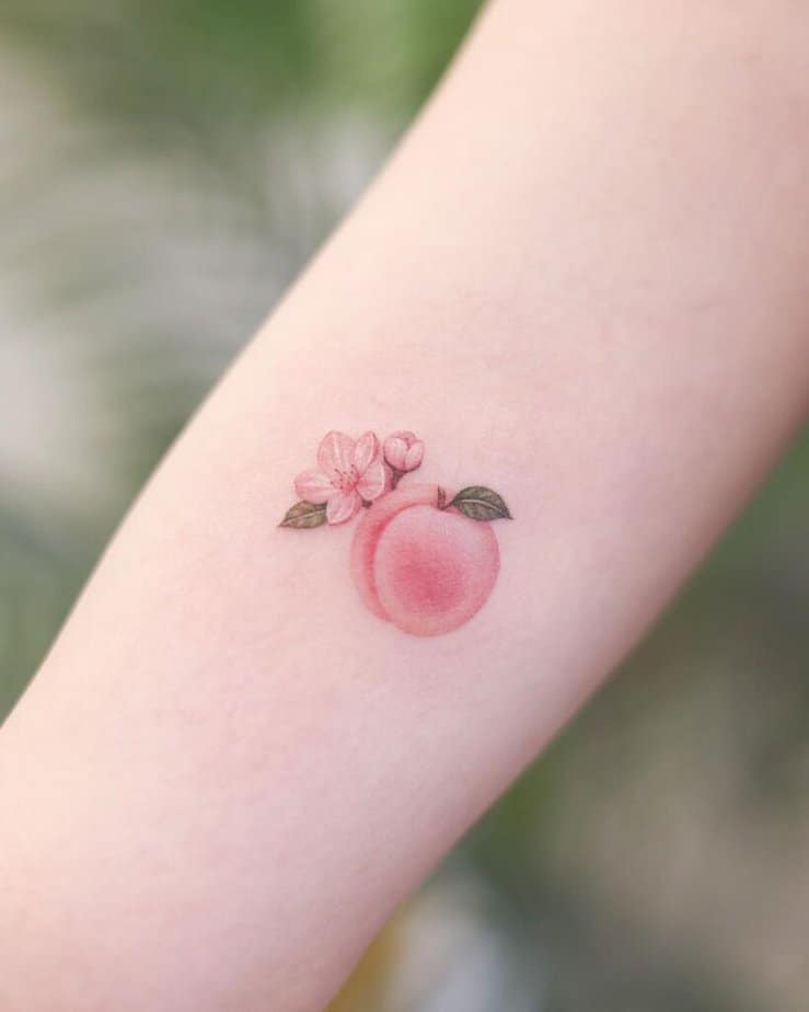 1. A pretty peach tattoo with peach blossom 