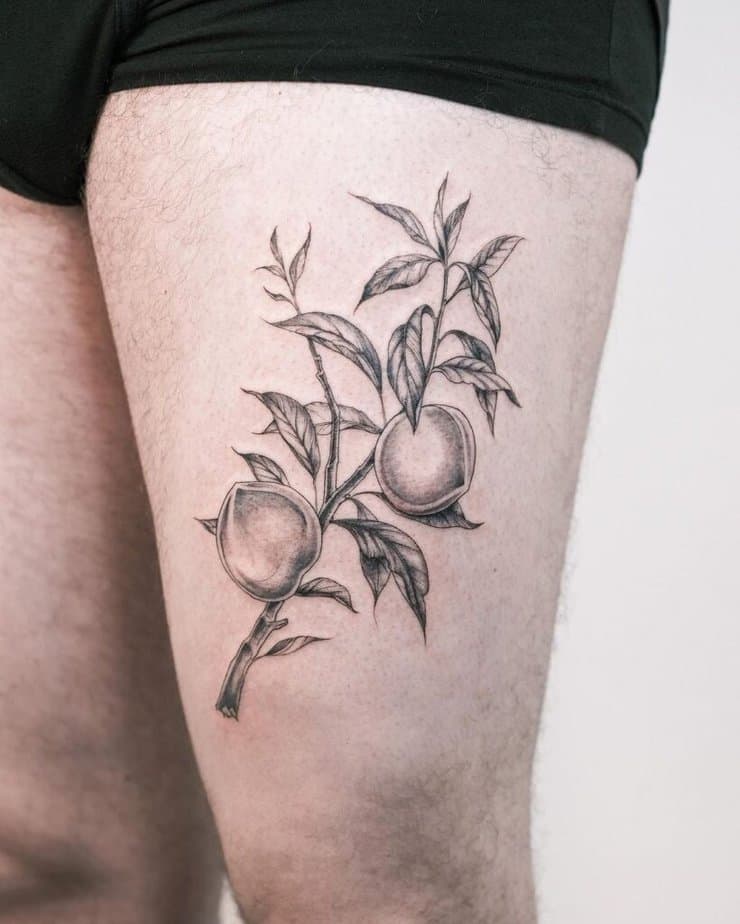 16. A tattoo of a peach on the thigh 