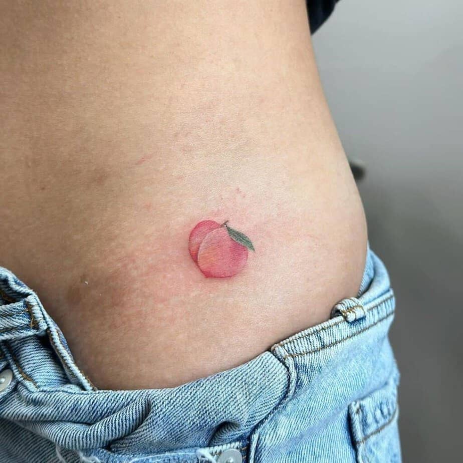5. A tattoo of a peach on the side of the stomach