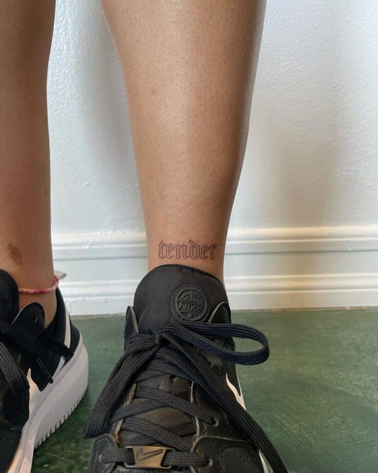 8. A word ankle tattoo