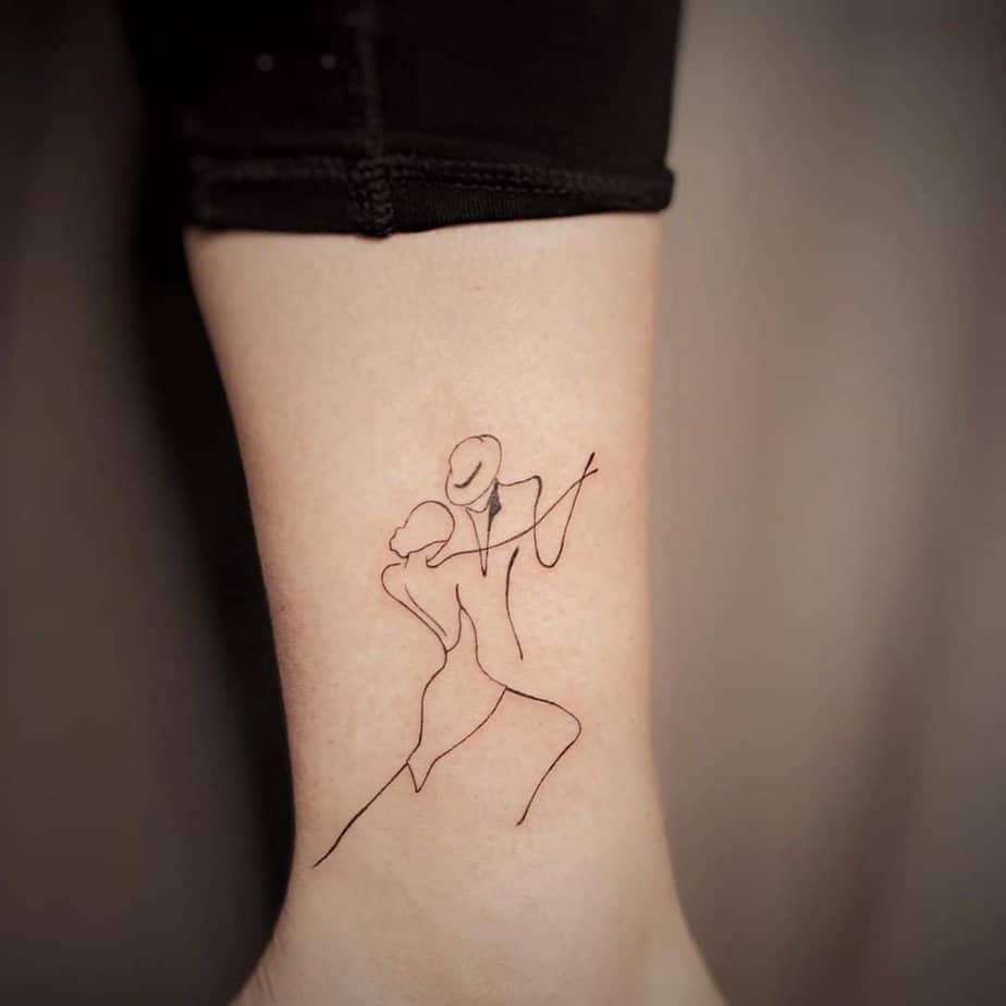 13. A line art tattoo of two dancers
