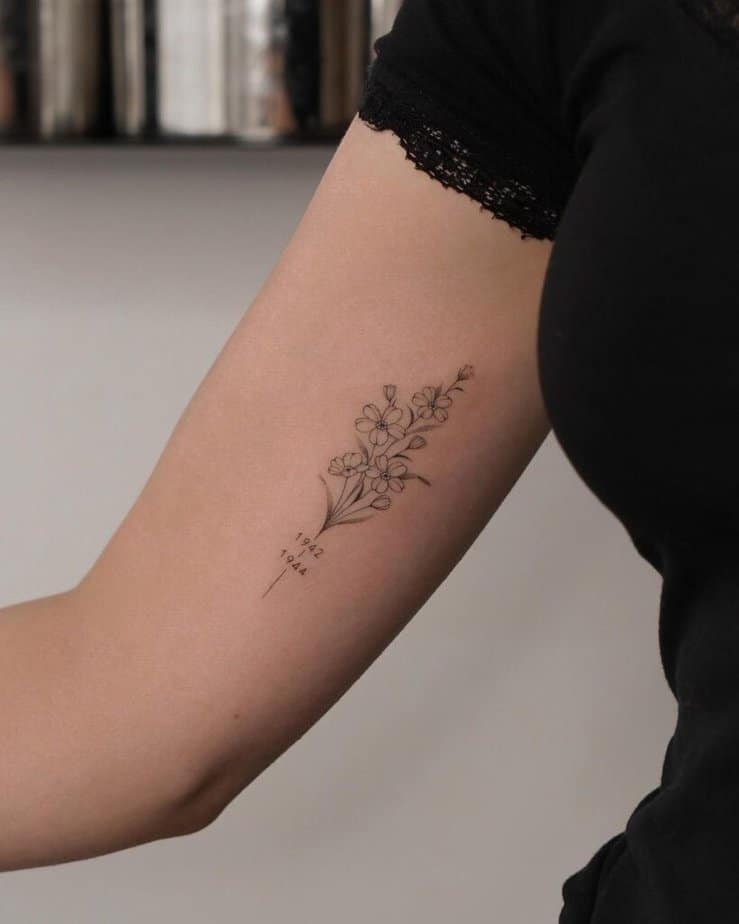 11. A daisy tattoo with a date