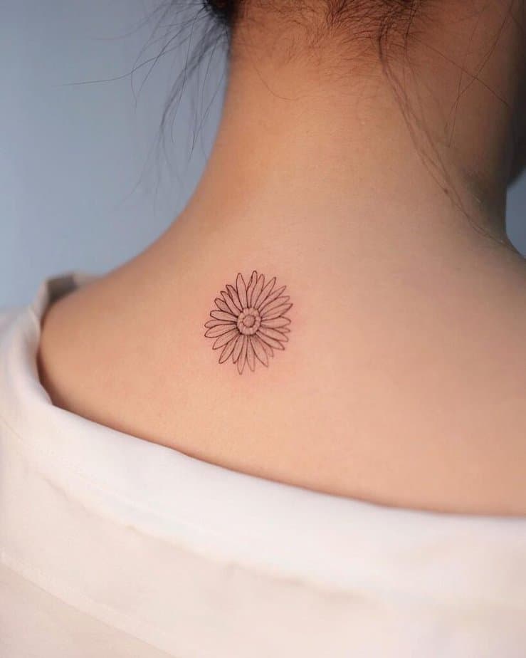 12. A daisy tattoo on the neck