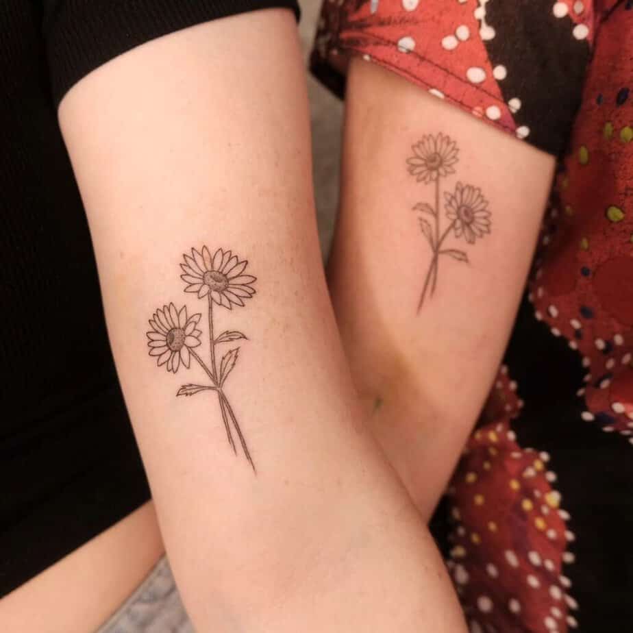 13. Matching daisy tattoos 