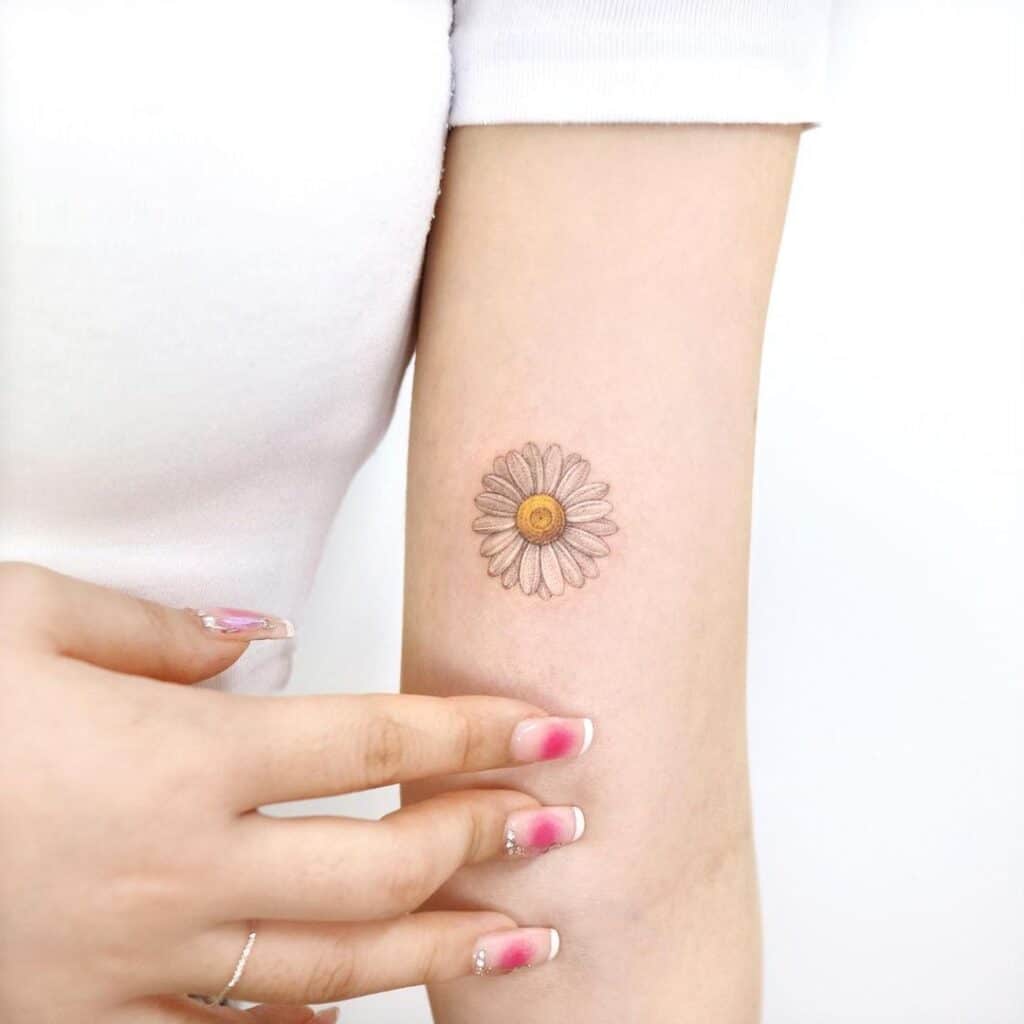 14. A white daisy tattoo 