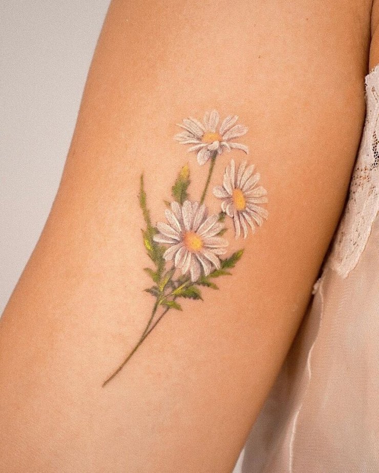 15. A tattoo of a bouquet of white daisies 