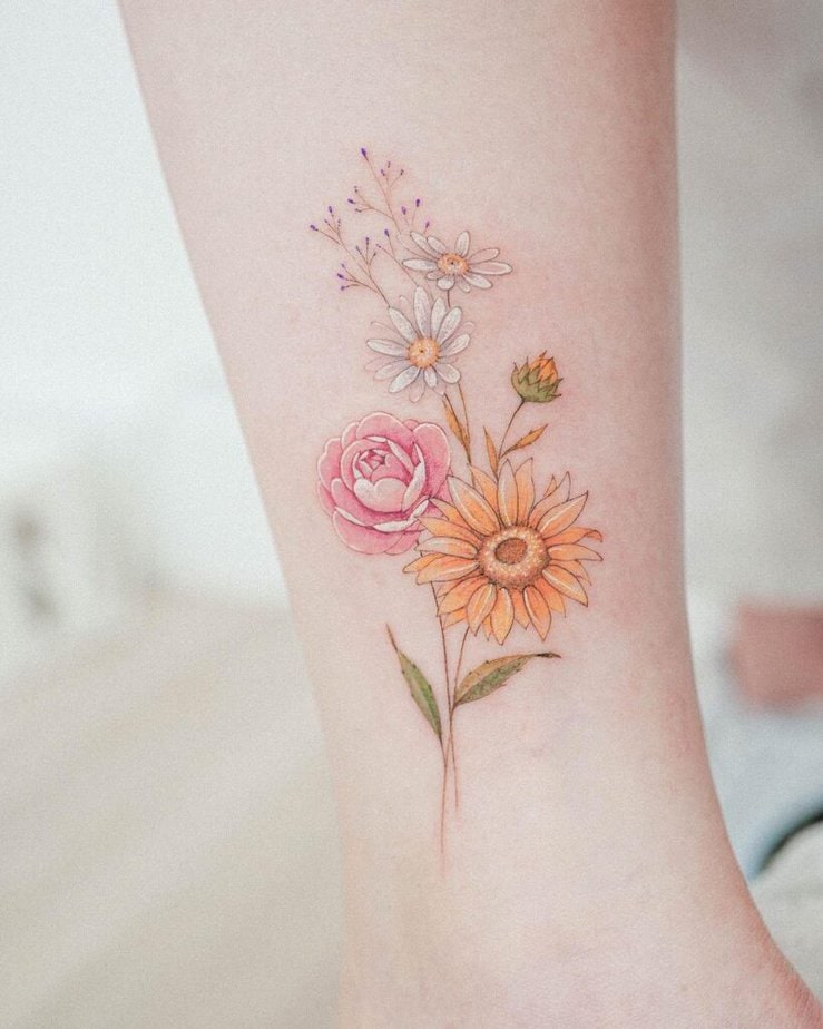 21. A daisy, sunflower, and camellia tattoo 