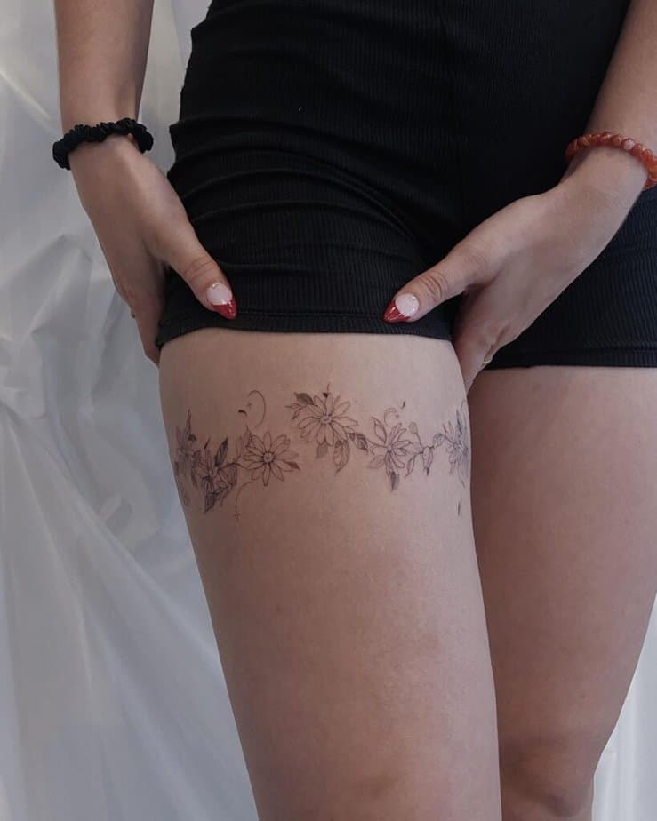 23. A daisy chain tattoo around the thigh 