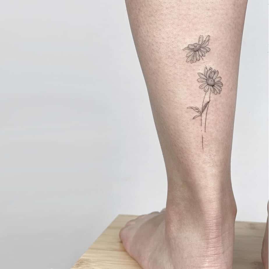 24. A daisy tattoo above the ankle 