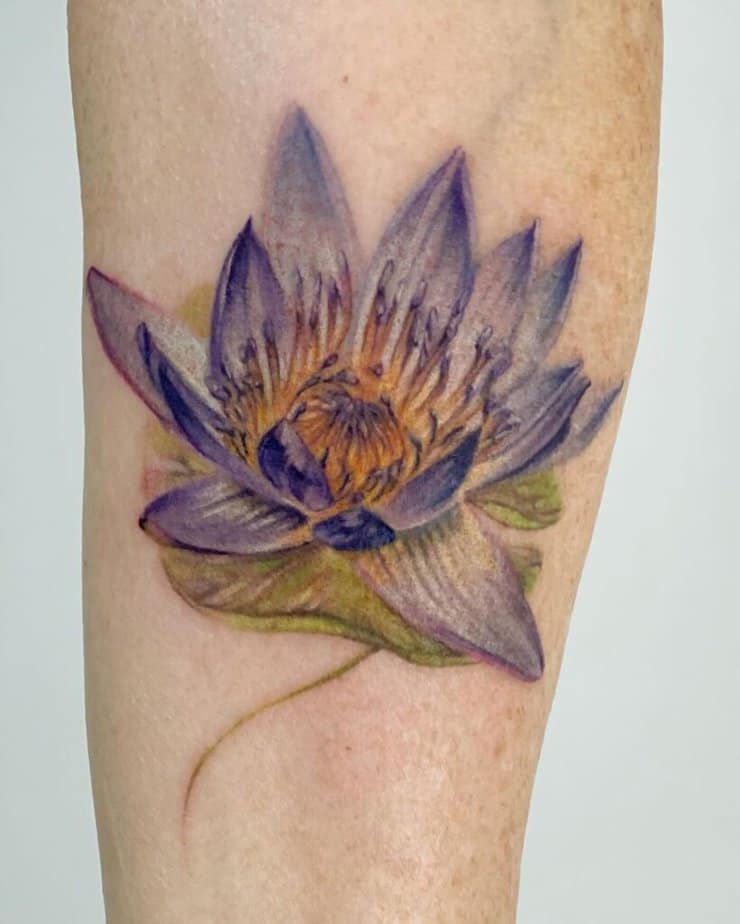 9. A realistic water lily tattoo 