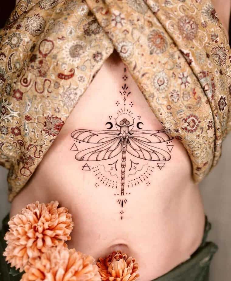 12. An ornamental tattoo of a dragonfly on the sternum 