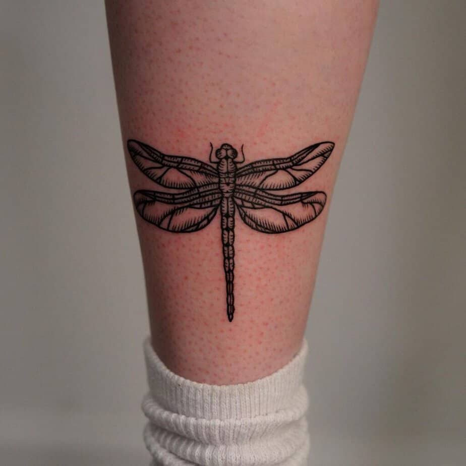18. A dragonfly tattoo on the leg