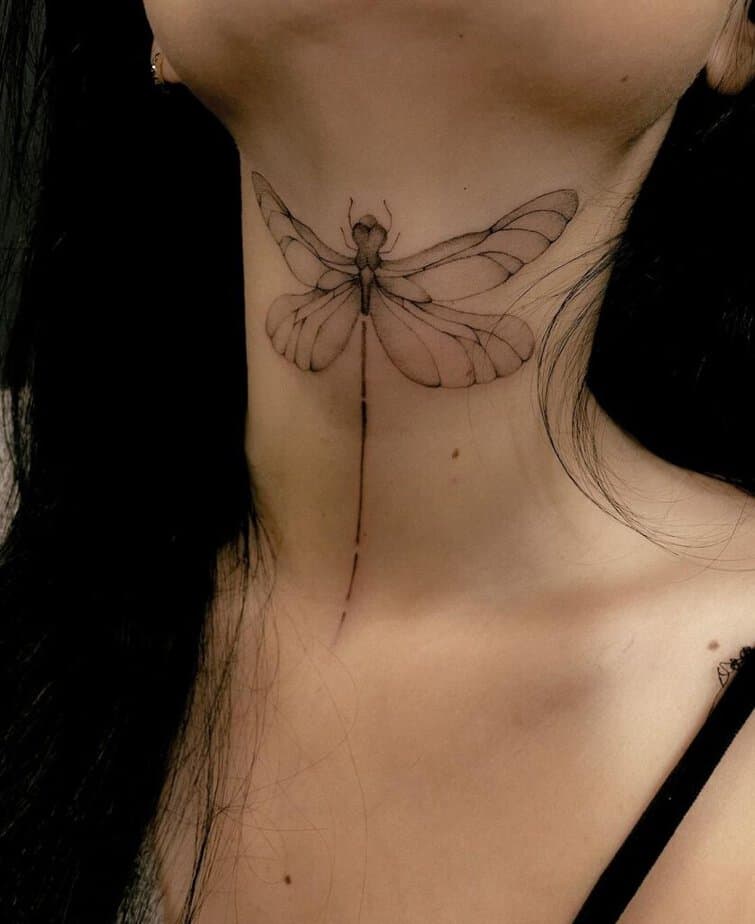 21. A tattoo of a dragonfly on the neck