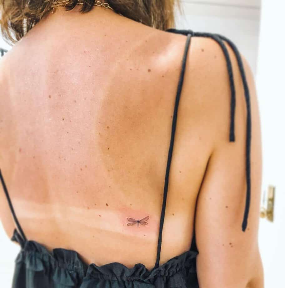 23. Un piccolo tatuaggio di una libellula sulla schiena