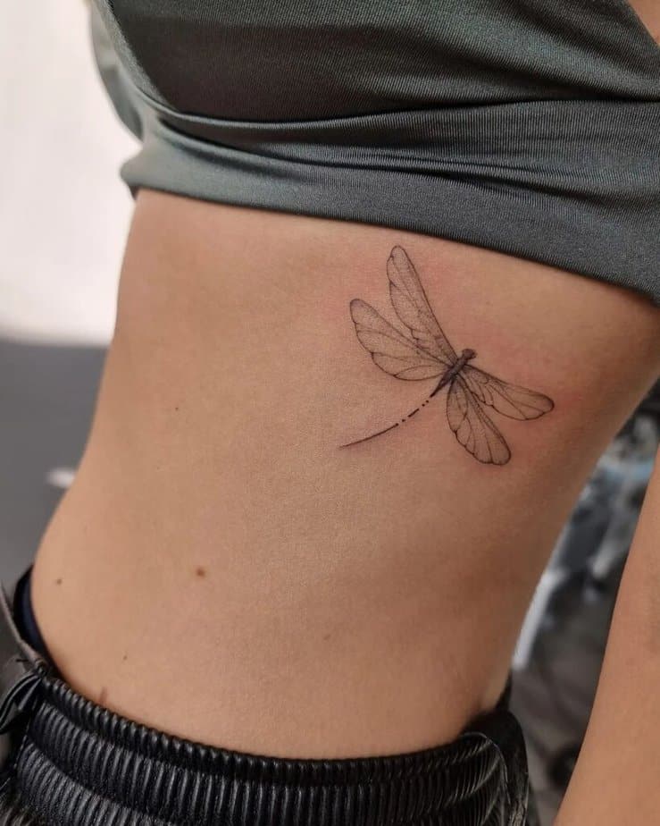 24. A tattoo of a dragonfly on the ribcage