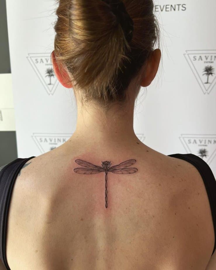 6. A tattoo of a dragonfly on the back 