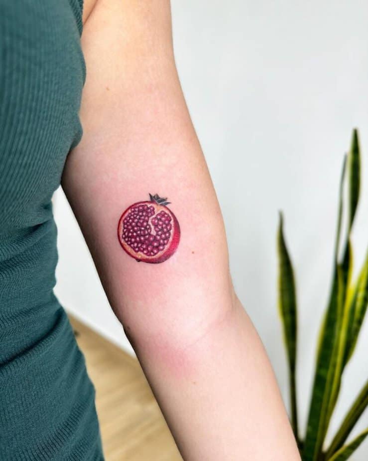 19. A pomegranate tattoo on the bicep 