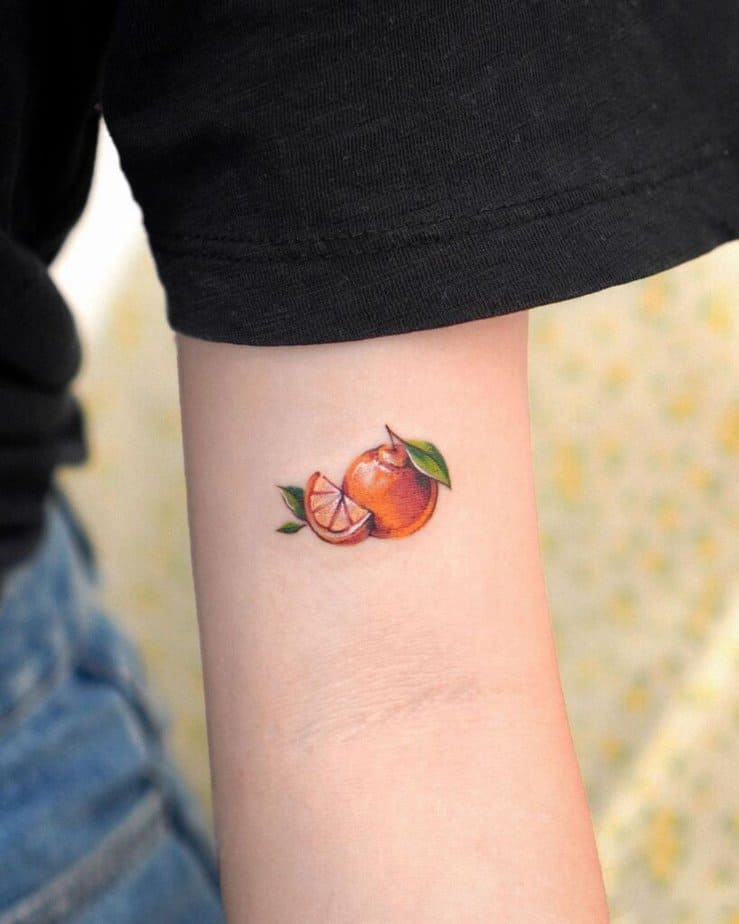2. A tattoo of an orange on the bicep 