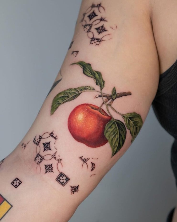 23. A tattoo of an apple on the bicep
