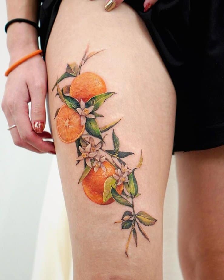 24. A tattoo of oranges on the thigh