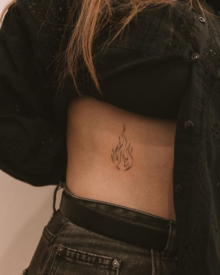 12. A flame tattoo on the side of the stomach 