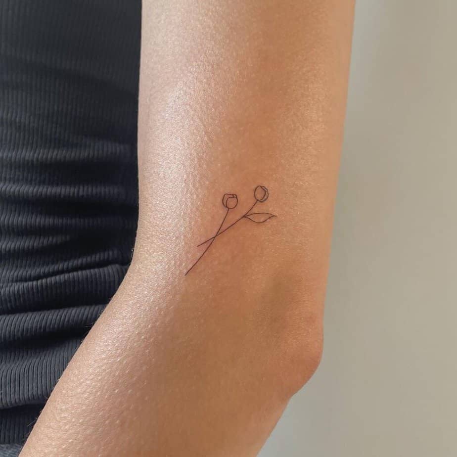 3. A dainty flower tattoo on the elbow