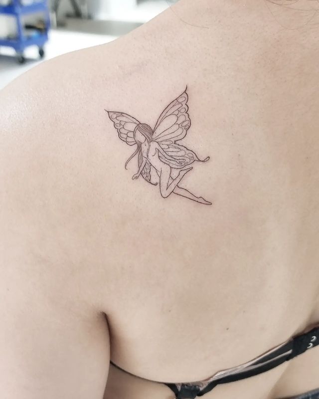 4. Fine-line fairy tattoo