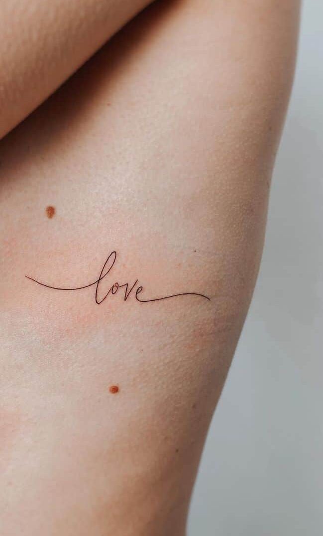 A tattoo of “love” on the ribcage