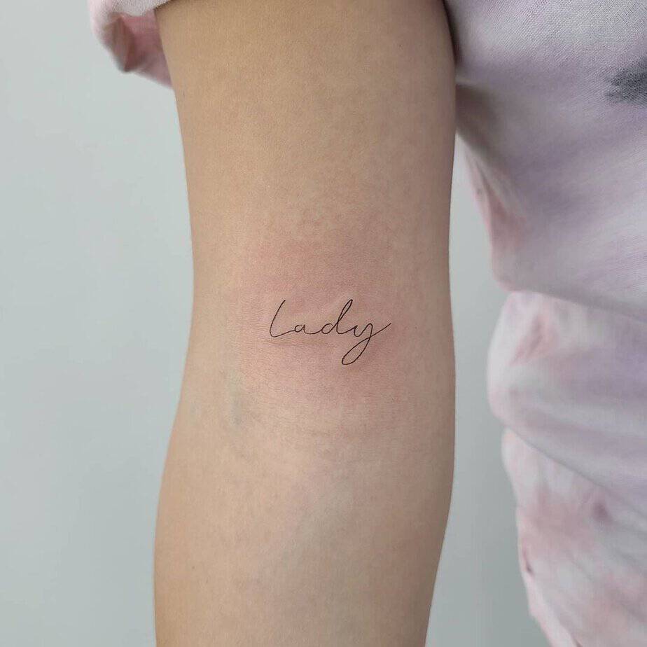 19. A “lady” tattoo on the upper arm