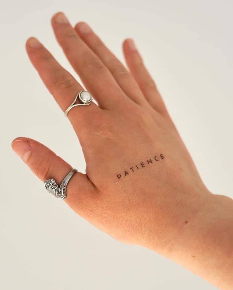 A “patience” tattoo on the hand
