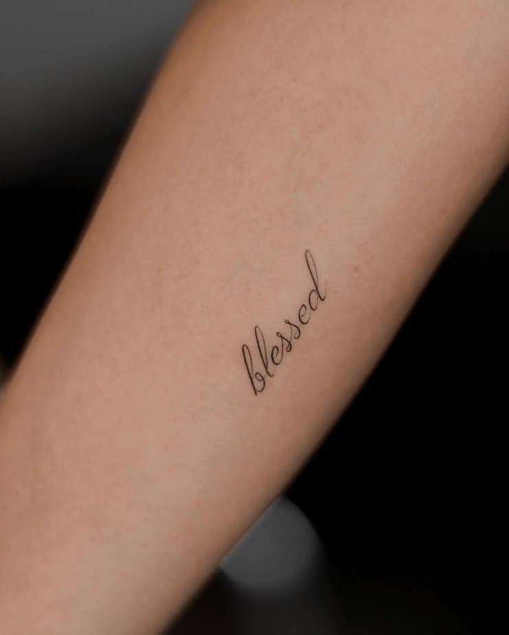 A “blessed” tattoo on the arm