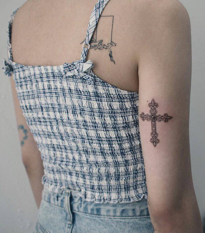 A simple cross tattoo on your arm