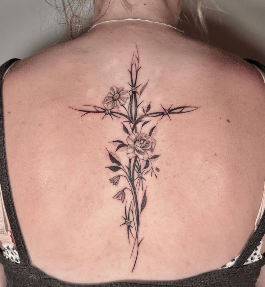 A feminine cross tattoo on your back