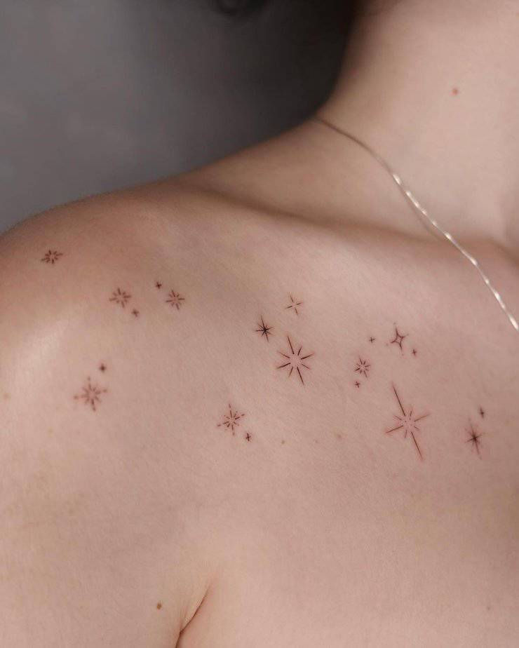 1. A sparkle tattoo design on the collarbone