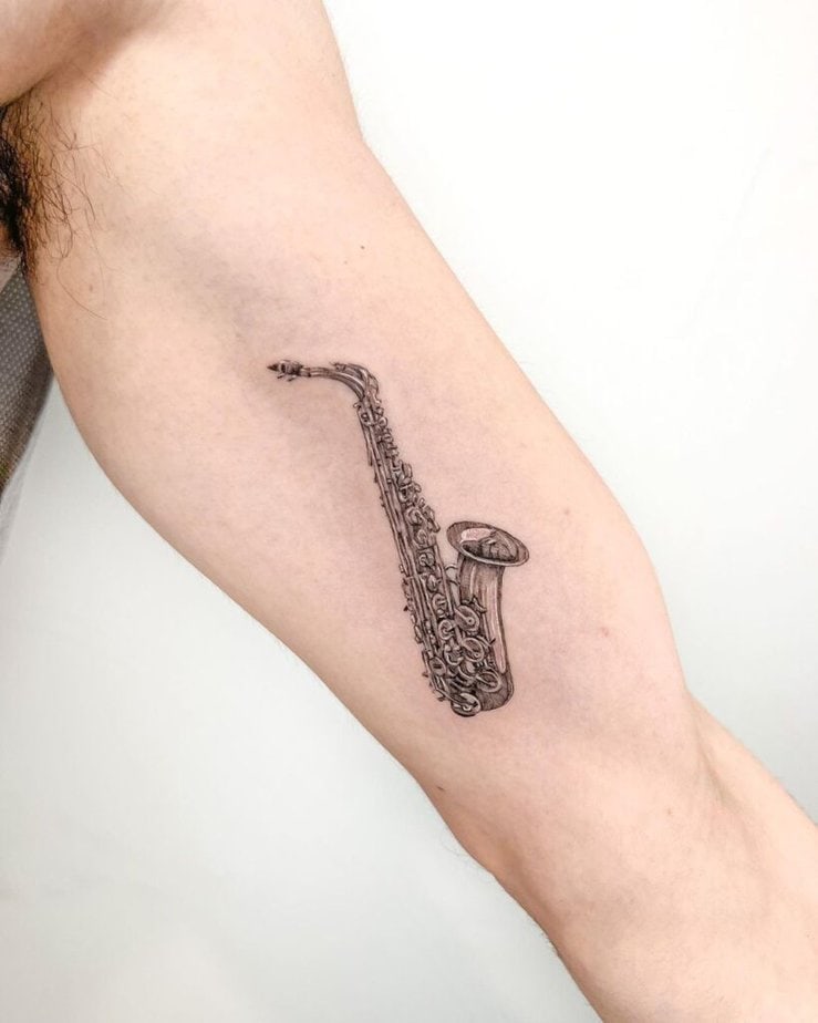 13. A saxophone tattoo on the inner arm