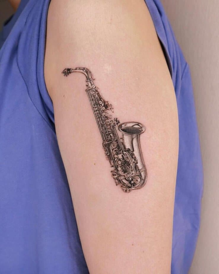 15. A sax tattoo on the upper arm