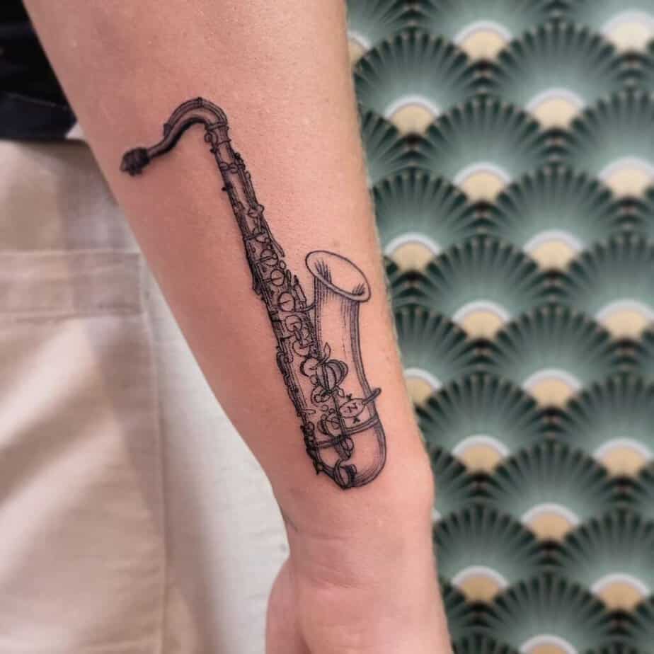 16. A sax tattoo on the outside of the arm